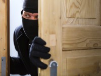 Burglary crime - burglar opening a door